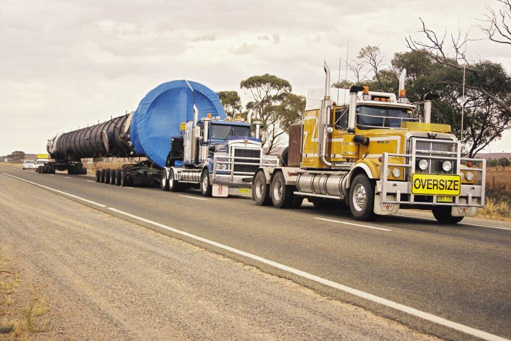 Road Trains (oversize) moving mining pipe, Central Australia © Hans Boessum