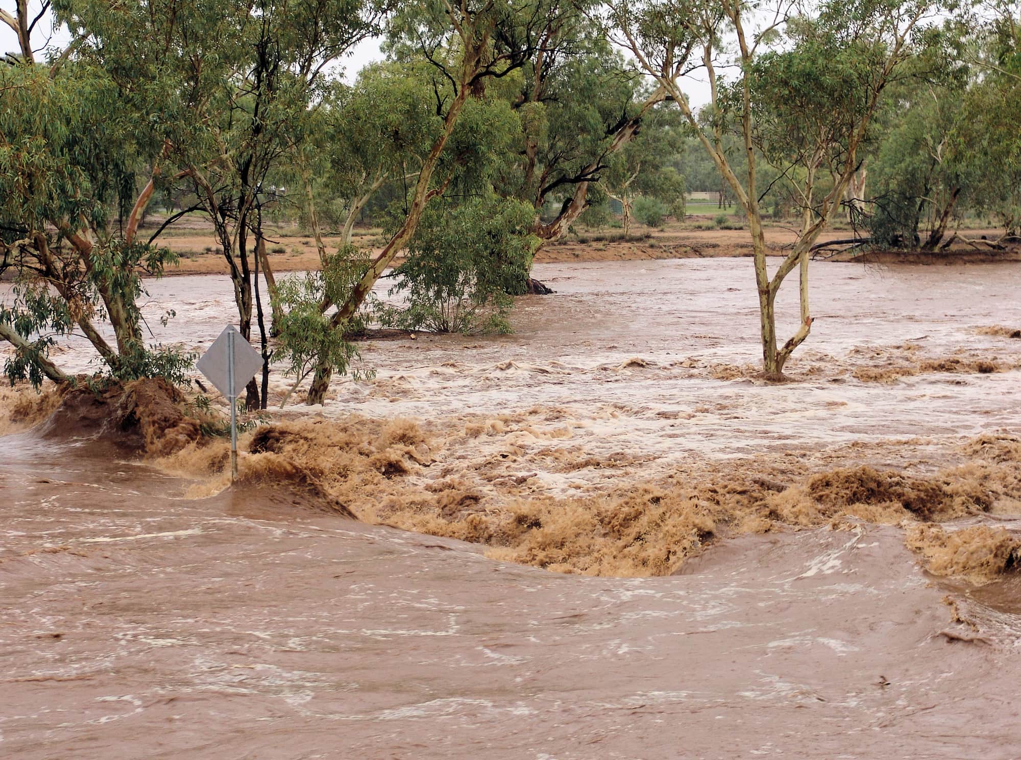 Water flowing swiftly over Undoolya Road causeway down the Todd River, Alice Springs, 9 Jan 2010