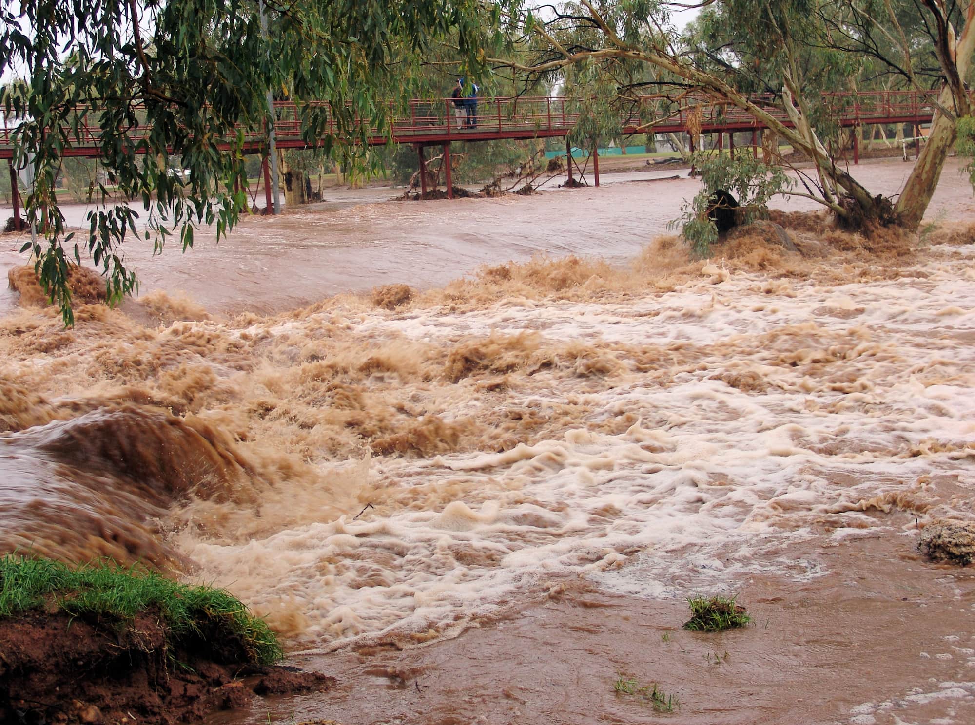 Water flowing swiftly over Undoolya Road causeway down into the Todd River, Alice Springs, 9 Jan 2010