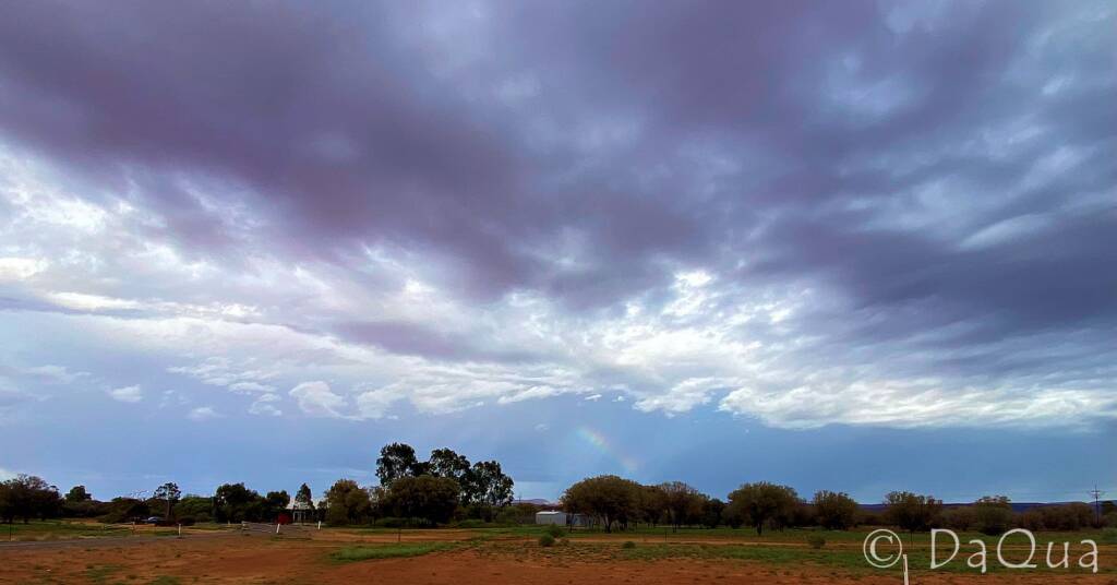 Rainbow beckoning under a cloudy sky © DaQua