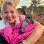 Holding a baby kangaroo at the Kangaroo Sanctuary, Alice Springs