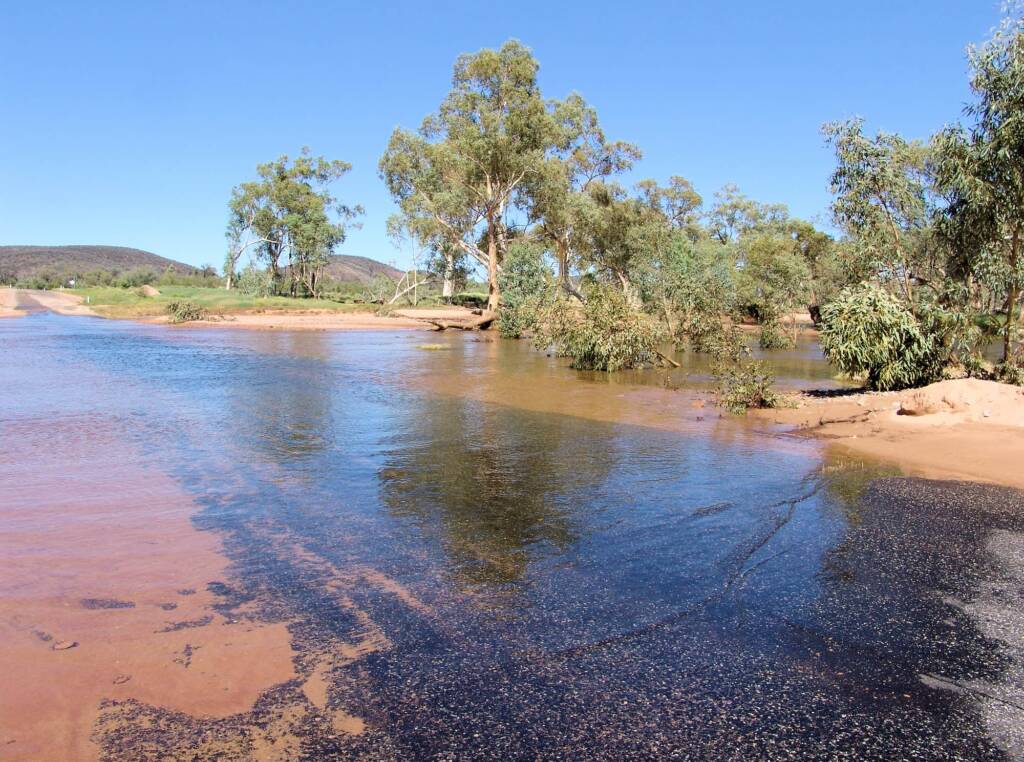 Hugh River flowing across Namatjira Drive, West MacDonnell Ranges