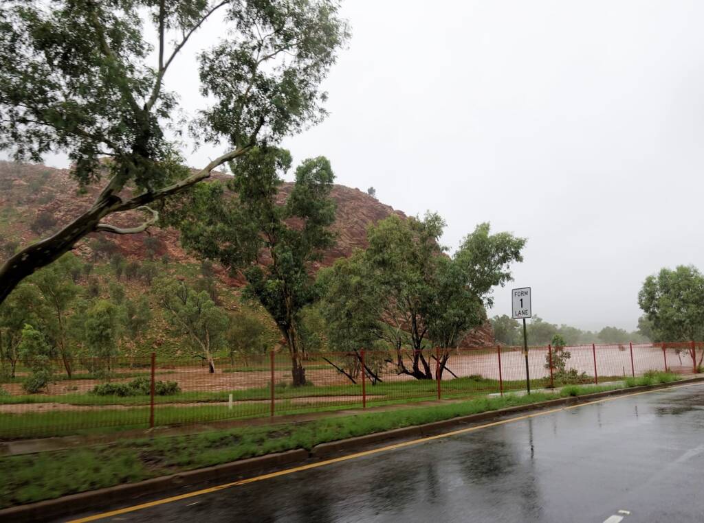 Driving through Heavitree Gap with the Todd River in flow, Alice Springs, NT