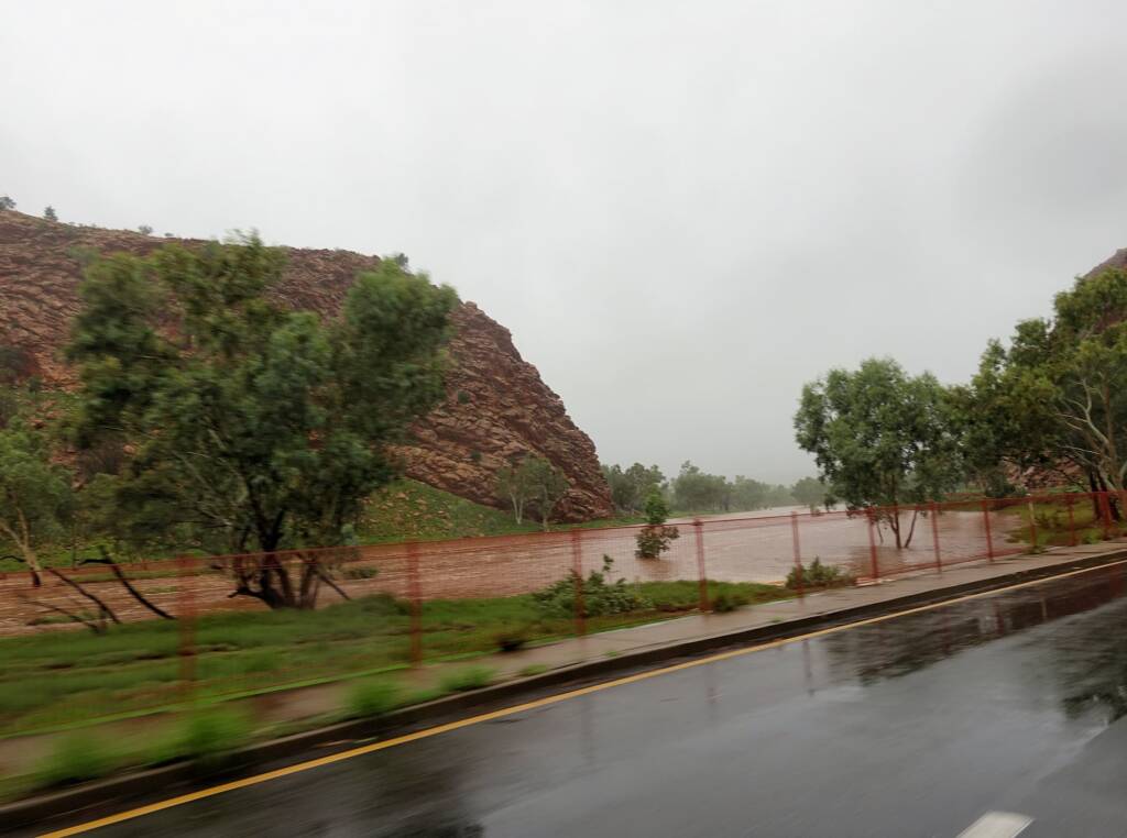 Driving through Heavitree Gap with the Todd River in flow, Alice Springs, NT