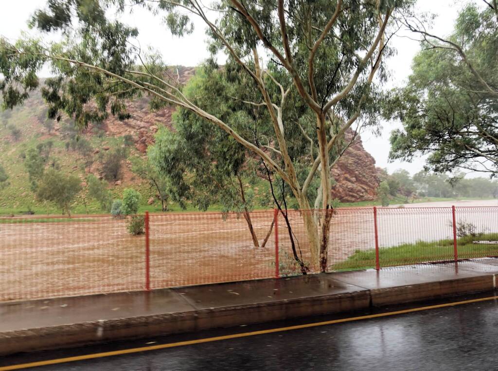 Driving through Heavitree Gap with the Todd River in flow, Alice Springs, NT