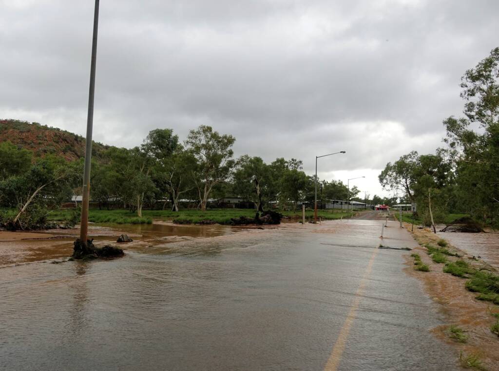 Todd River flowing across Palm Circuit, Alice Springs, NT
