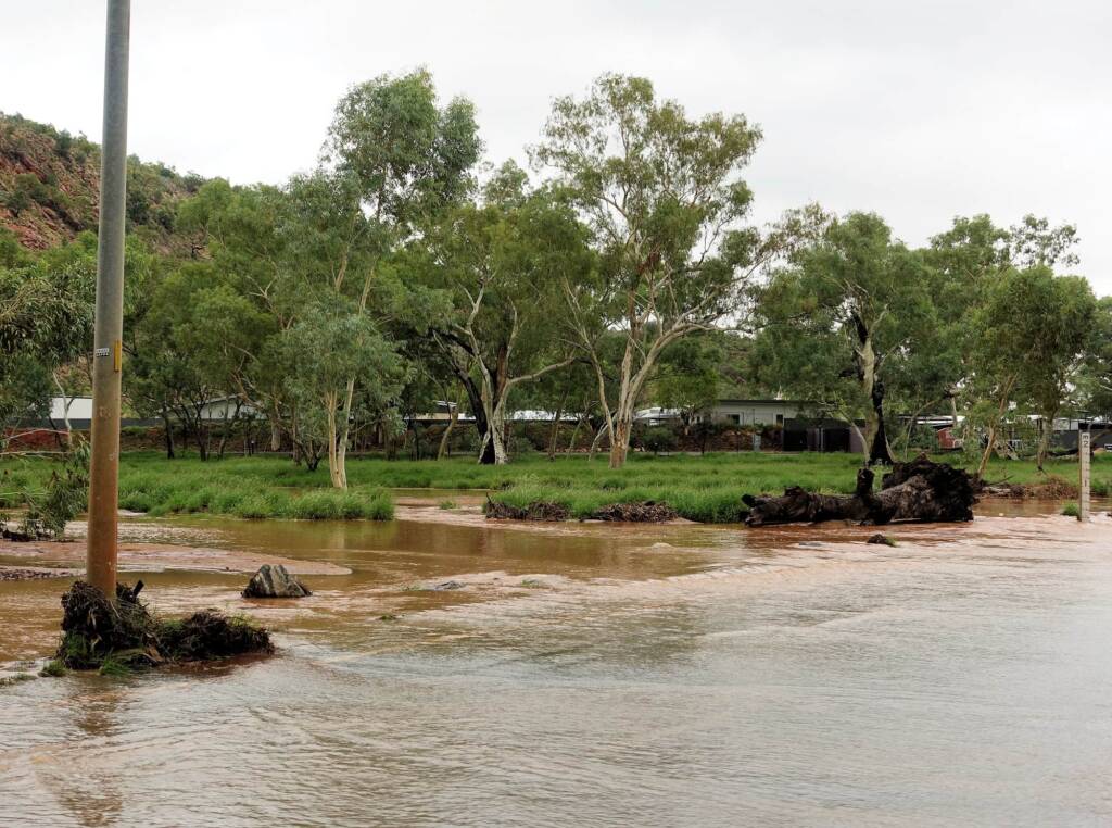 Todd River flowing across Palm Circuit, Alice Springs, NT