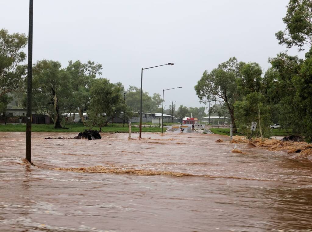 Todd River raging across Palm Circuit, Alice Springs, NT