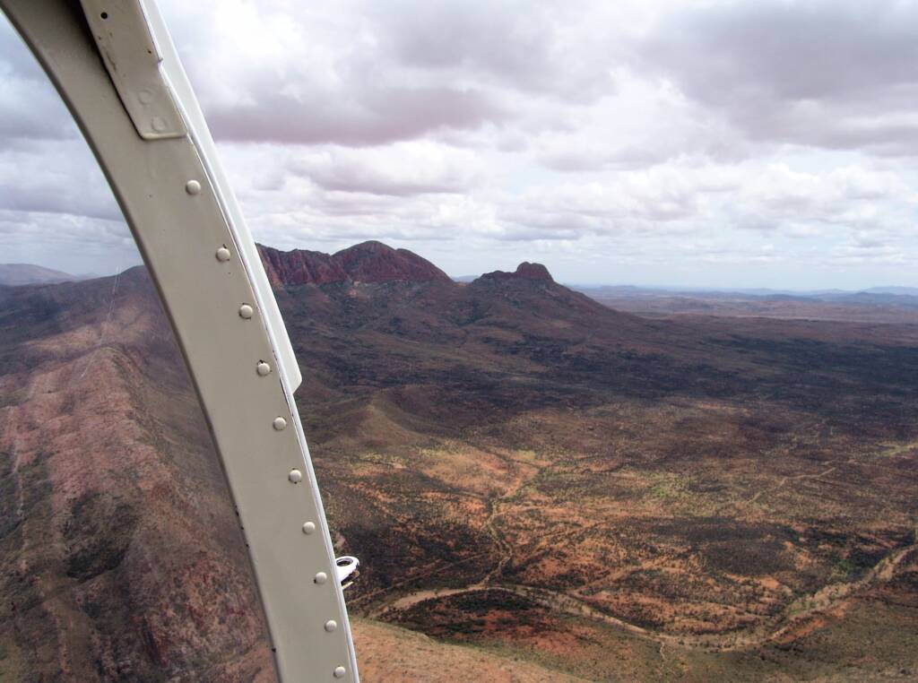 Helicopter ride on a cloudy day over Mount Sonder, West MacDonnell Range