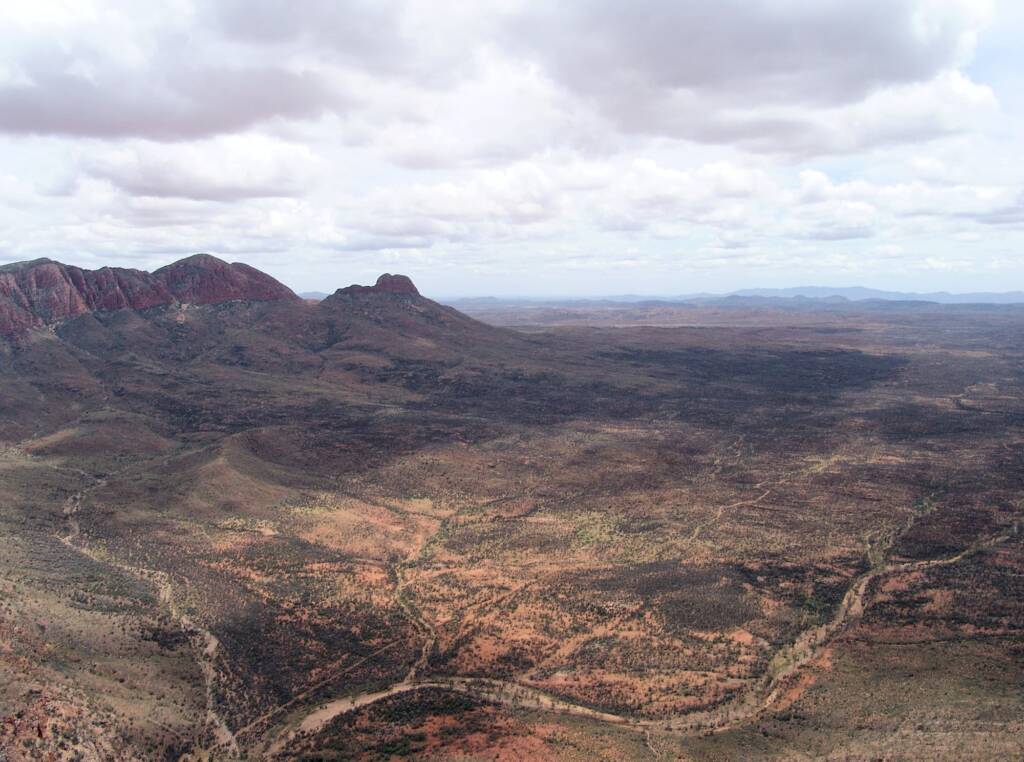 Helicopter ride on a cloudy day over Mount Sonder, West MacDonnell Range