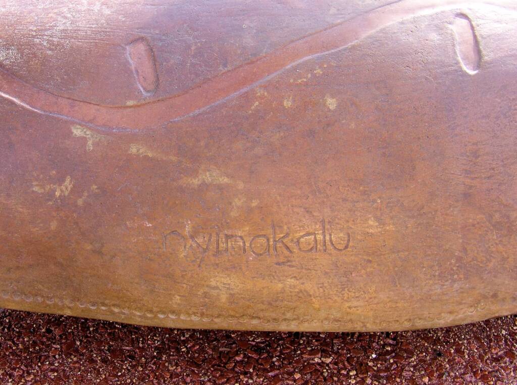 Coolamon - Walpiri language: Nyinakalu - Translation: 'come, sit, be'