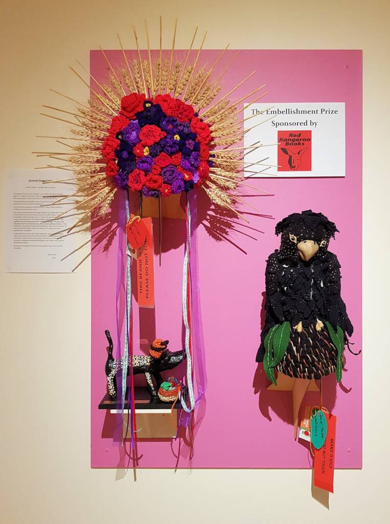 Ukranian Flower Crown by Karen Lynch and The Unwilling Traveller by Maggie Pereyra, Alice Springs Beanie Festival 2023