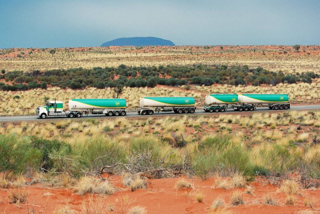 BP Road Train passing Uluru (Ayres Rock), Central Australia © Hans Boessum