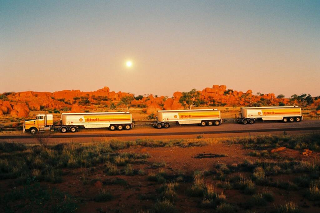 Shell road train passing Karlu Karlu (the Devil Marbles), Central Australia NT © Hans Boessum