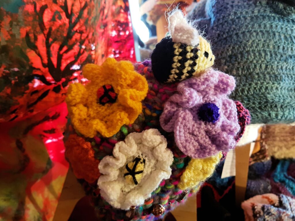 Bees on spring flowers by Loraine Melis, Alice Springs Beanie Festival 2025