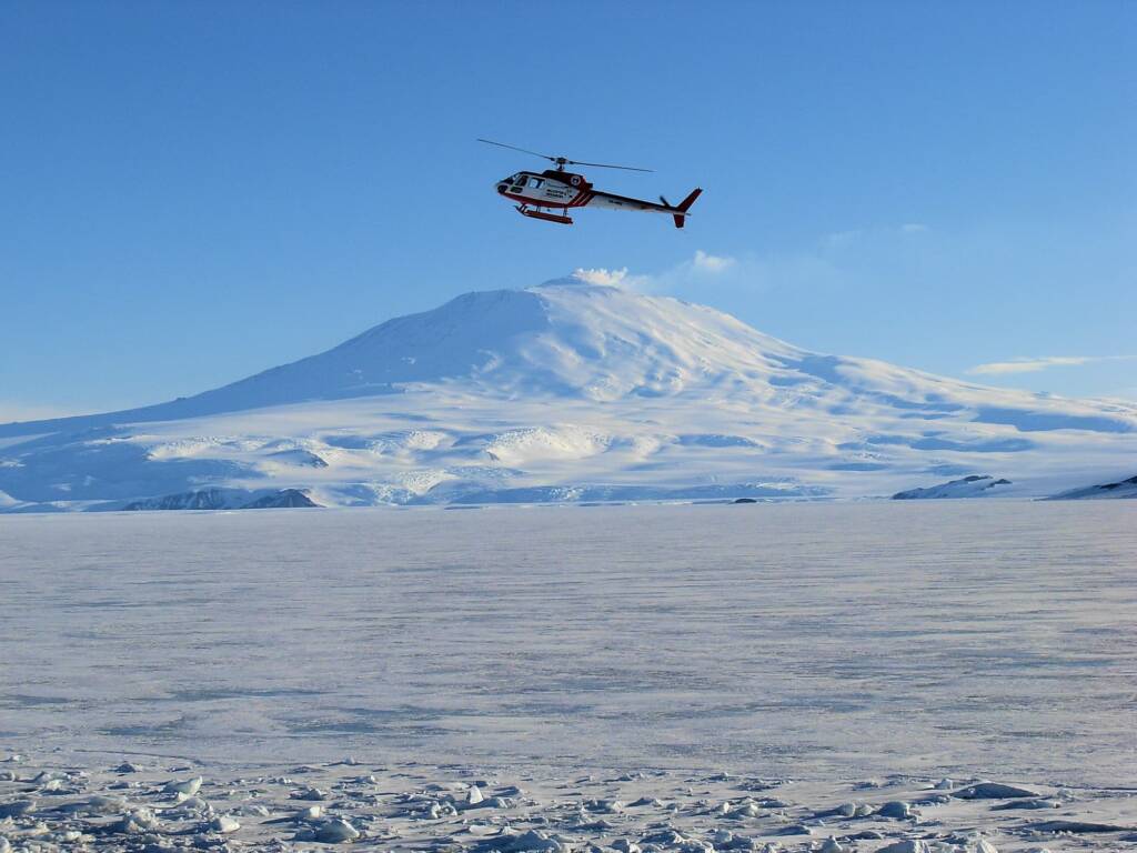 Mount Erebus and helicopter, Antarctica © Jennifer Cooke
