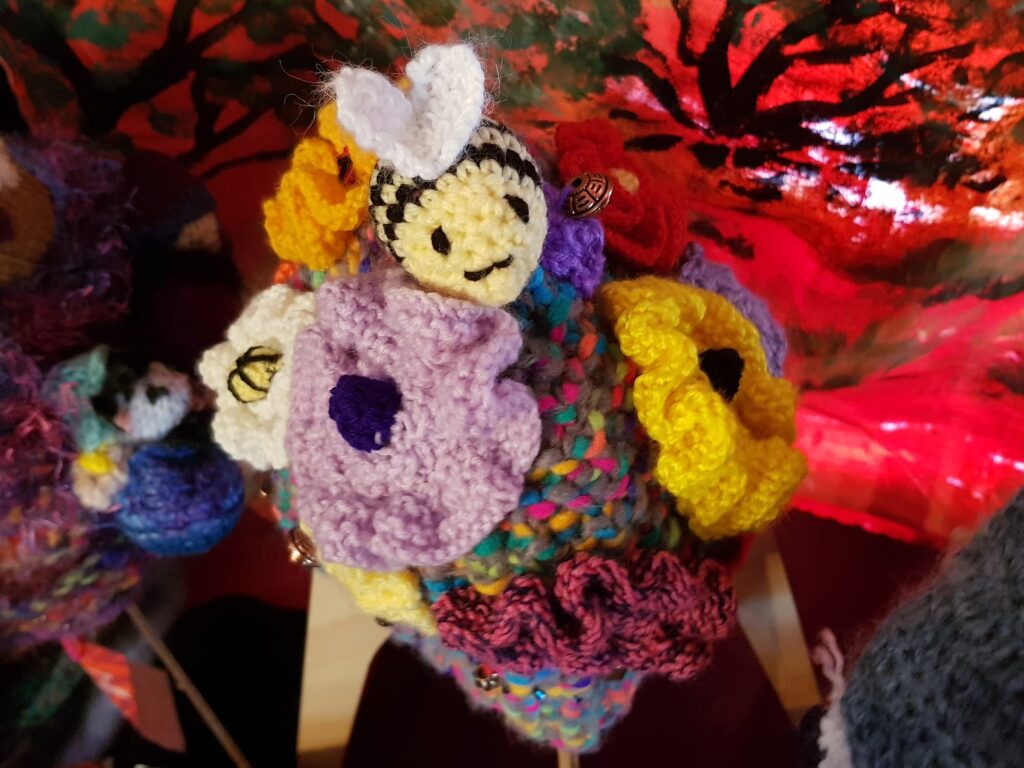Bees on spring flowers by Loraine Melis, Alice Springs Beanie Festival 2025
