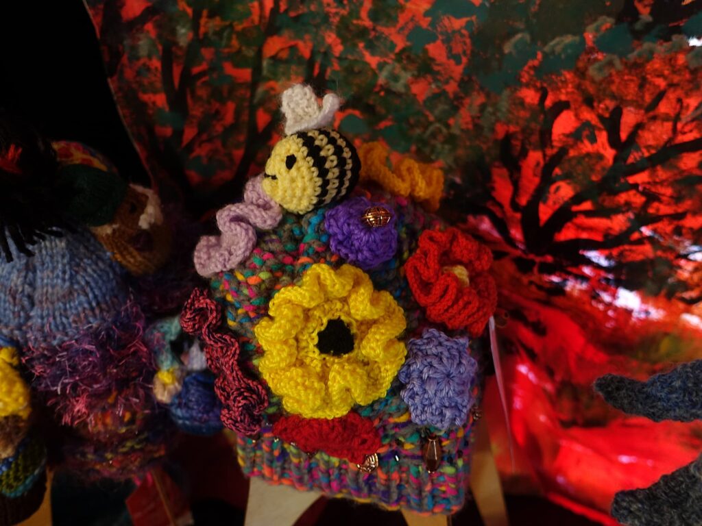 Bees on spring flowers by Loraine Melis, Alice Springs Beanie Festival 2025