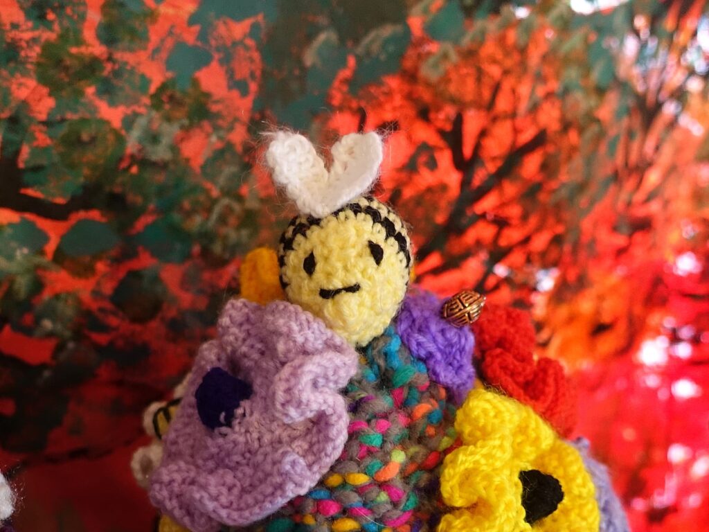 Bees on spring flowers by Loraine Melis, Alice Springs Beanie Festival 2025