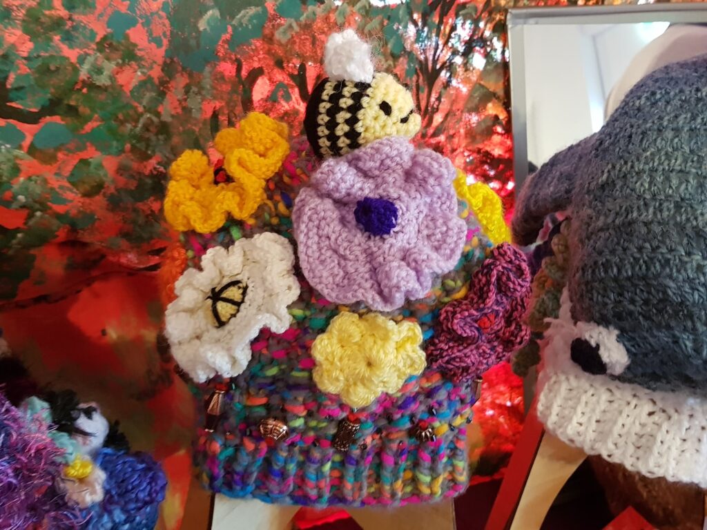 Bees on spring flowers by Loraine Melis, Alice Springs Beanie Festival 2025