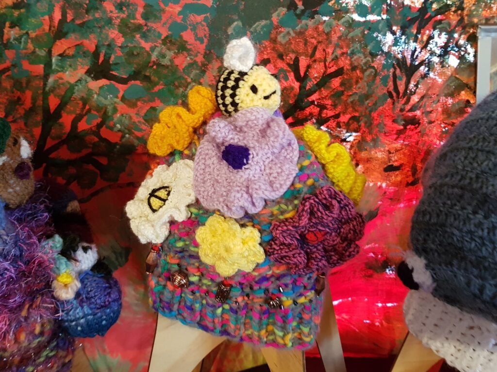 Bees on spring flowers by Loraine Melis, Alice Springs Beanie Festival 2025