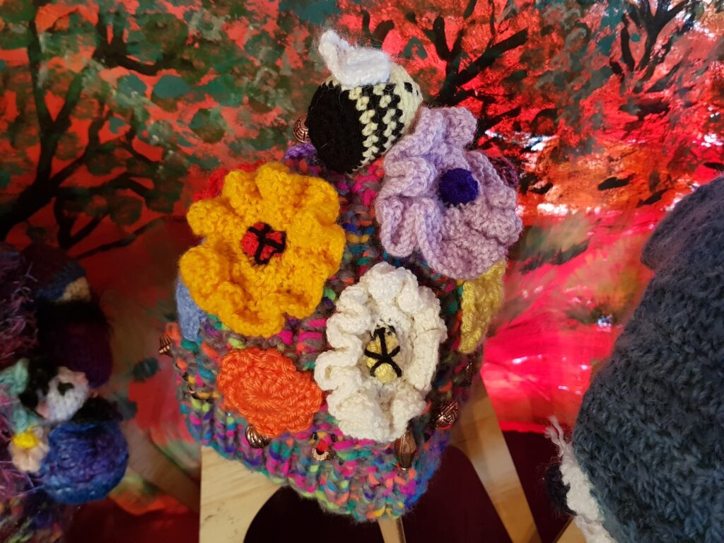 Bees on spring flowers by Loraine Melis, Alice Springs Beanie Festival 2025