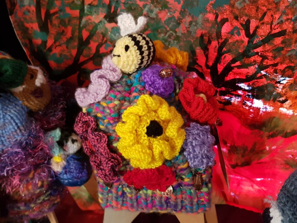 Bees on spring flowers by Loraine Melis, Alice Springs Beanie Festival 2025
