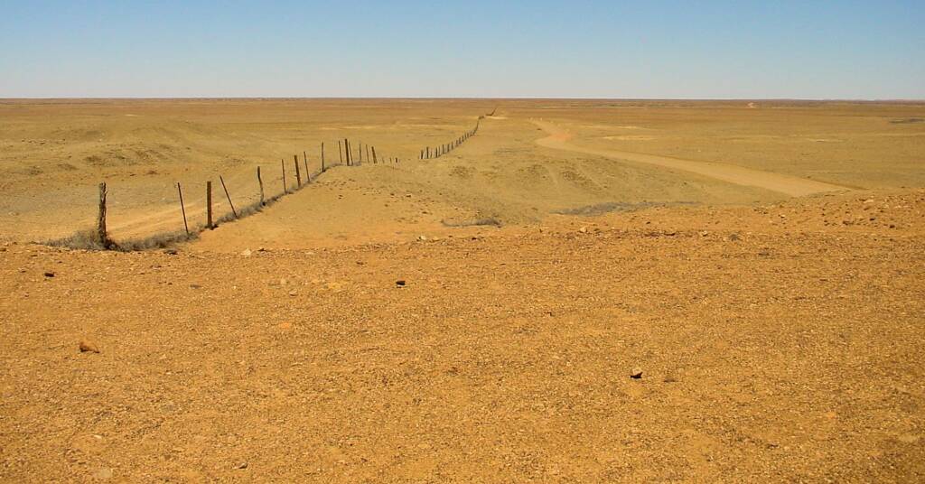 Dog fence passes by The Breakaways in South Australia