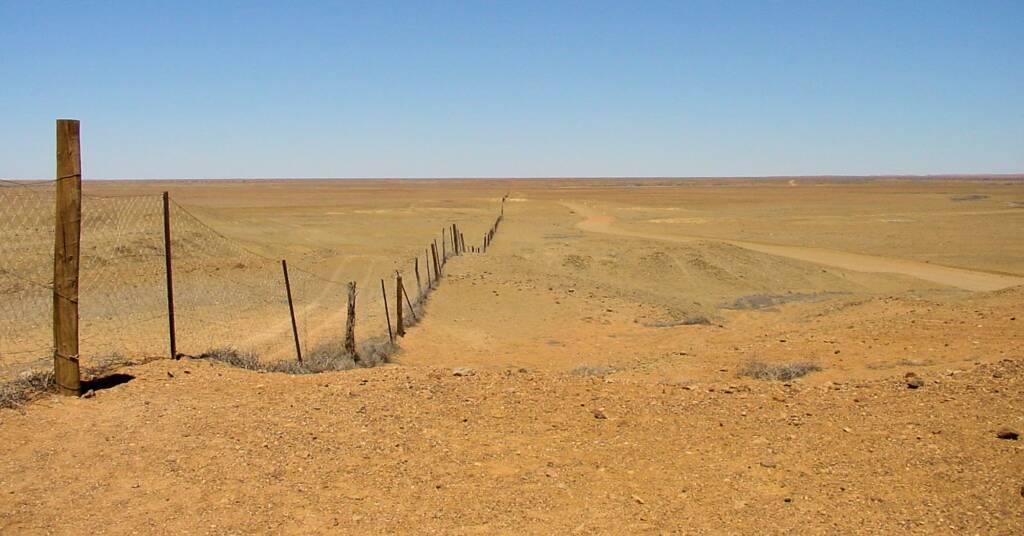 Dog fence passes by The Breakaways in South Australia