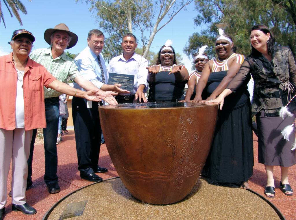 Key players and officials at the water urn in the Gathering Garden.