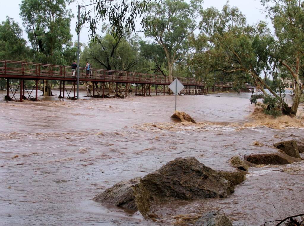Water flowing over Undoolya Road causeway and under the footbridge, Todd River, Alice Springs, 9 Jan 2010