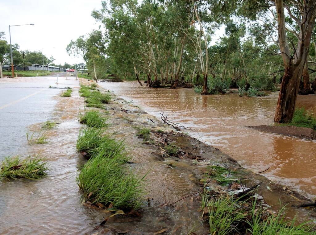 Todd River flowing across Palm Circuit, Alice Springs, NT