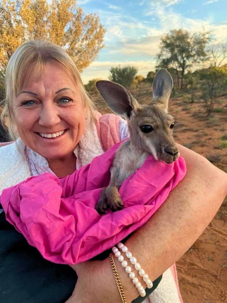 Holding a baby kangaroo at the Kangaroo Sanctuary, Alice Springs