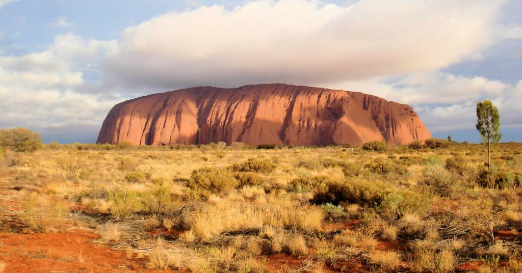 Uluru under a cloudy sky