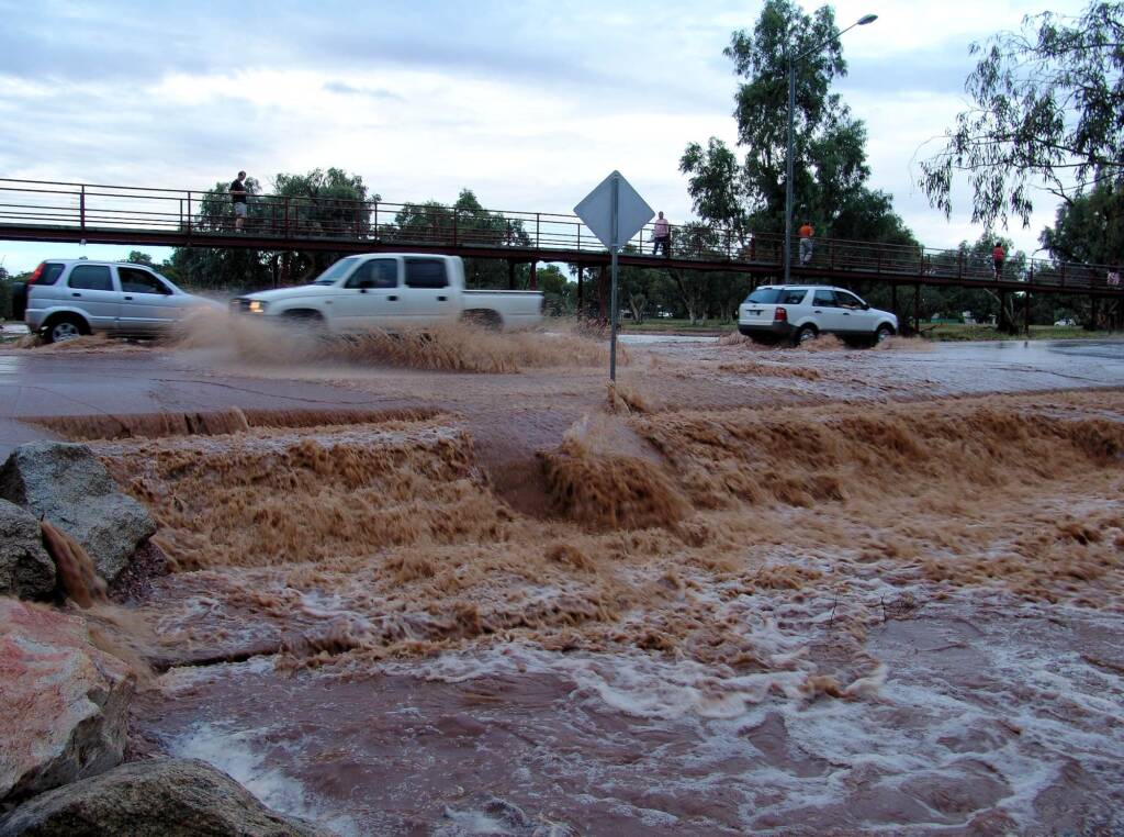 Todd River gushing over Undoolya Road, Alice Springs, 23 Feb 2010